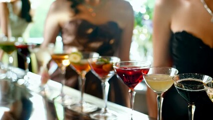 A group of friends enjoys a night out, clinking glasses and savoring colorful cocktails in a vibrant bar atmosphere
