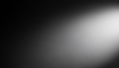 Fototapeta premium Soft Spotlight on Textured Black Surface. Gradual Transition from Dark to Light Gentle Illumination Effect with Fine, Subtle Grainy Details. Minimalist Aesthetic