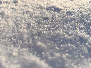 Fototapeta premium Fresh snow crystals close up, snowflakes. Blurred background, copy space