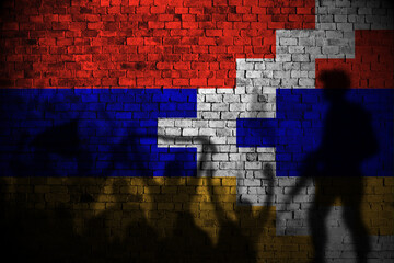 nagorno flag painting on brick wall and Protesters shadow