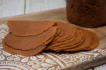 Seitan or mock meat made with vital wheat gluten,  spices. Cooked in ham maker and sliced.