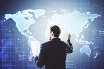 Businessman interacting with digital world map on virtual screen in modern office.