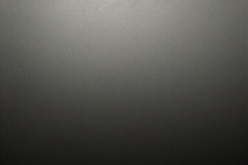 Texture of old gray paper closeup. Structure of a dense cardboard. The black background.