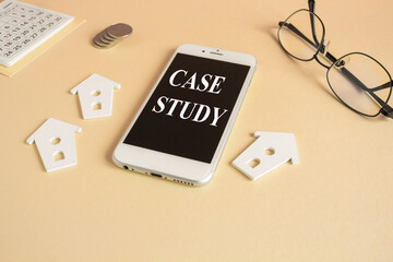 Concept words CASE STUDY on the mobile phone screen. Beautiful beige background. Glasses, miniature houses, coins. Concept text.