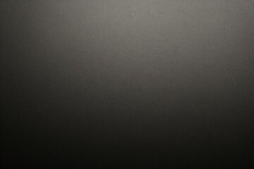 Texture of old gray paper closeup. Structure of a dense cardboard. The black background.