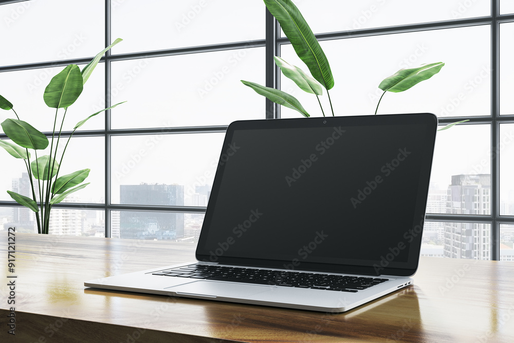 Poster modern laptop on wooden desk with city view through large windows. 3d rendering