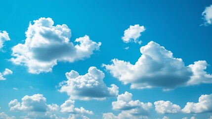 Blue sky with scattered fluffy white clouds.