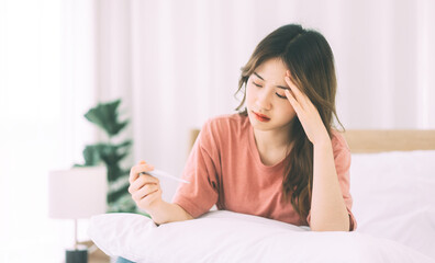 Depression young adult woman at bedroom in morning got fever and headache