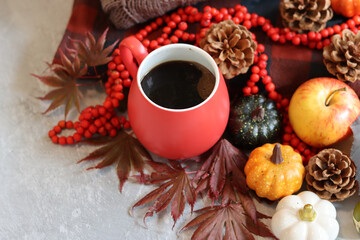 Fall season composition with cup of coffee and autumn decorations on a table. Warm autumn still life. 