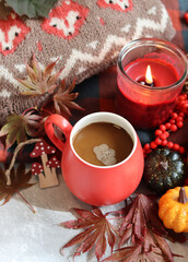 Fall season composition with cup of coffee and autumn decorations on a table. Warm autumn still life. 