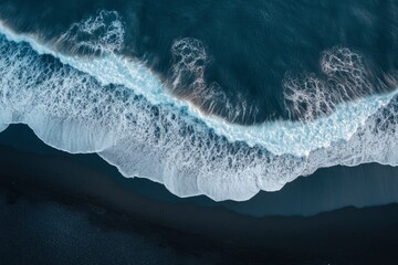 Fototapeta premium aerial top down view of beautiful white blue water waves splashing over dark beach , ai