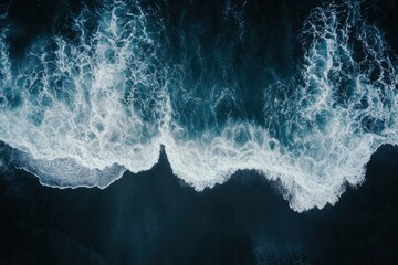 aerial top down view of beautiful white blue water waves splashing over dark beach , ai