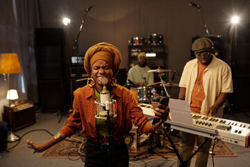 African American musicians rehearsing in studio with instruments and microphones creating lively music atmosphere perfect for recording