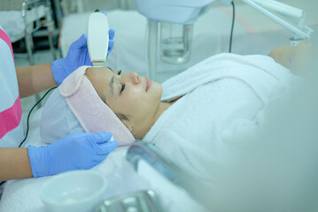 Beauty therapist doing facial treatment