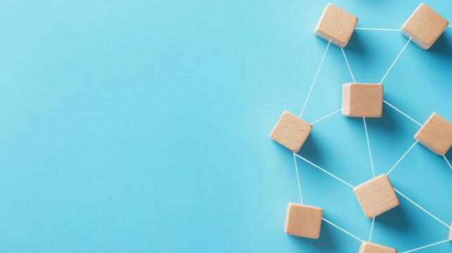 Interconnected Wooden Blocks on a Blue Background, Symbolizing the Strength of Teamwork