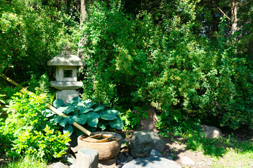 A serene Japanese Garden with a stone lantern, vibrant flora, and natural beauty for relaxation