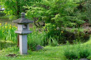 A serene Japanese Garden with a stone lantern, vibrant flora, and natural beauty for relaxation
