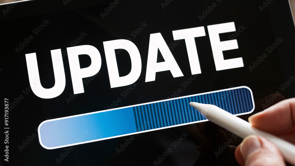Poster update progress on digital tablet screen with stylus interaction – close-up of software or system up