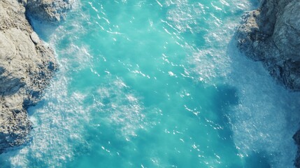 Aerial view of turquoise ocean waves crashing on rocky coastline, natural seascape with clear blue waters