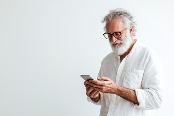 Smiling senior man watching photos on his smartphone on a white background