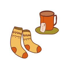 Cozy socks and a warm cup of tea on a soft surface