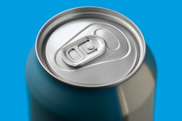 Aluminum can on blue background close-up. Selective focus