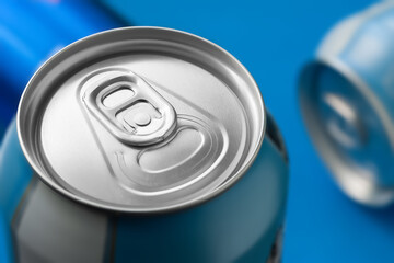 Aluminum beer can on blue background close-up