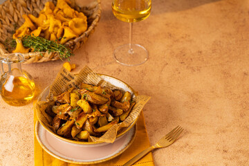 Vegetarian dish fried potatoes with garlic, parsley and chanterelle mushrooms closeup on a plate on the table. horizontal
