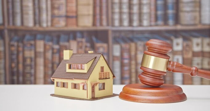 Legal issues, property, real estate law and transactions. A residential house beside the judge's gavel. The intersection of law and real estate in various aspect e.g property rights, contract, etc