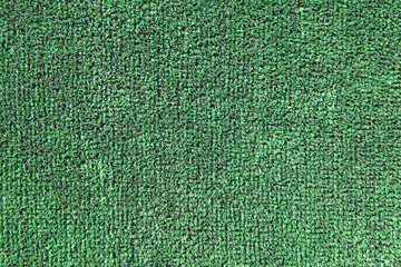 Green artificial grass. Green coating from above, texture, background.  Decorative grass for...