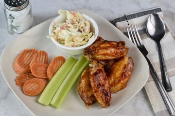 chicken wings  with carrots and celery