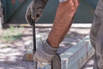 Carpenter clamps are fixed to boards. Gluing joinery in the workshop..