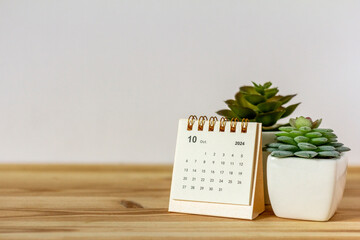 The desktop calendar for October 2024 is on the table.