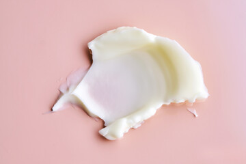 Texture of cosmetic butter on a pink background. Showcasing a thick and nourishing texture.