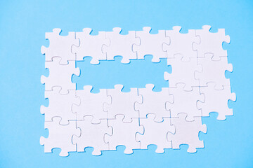 A puzzle with a missing piece is shown on a blue background