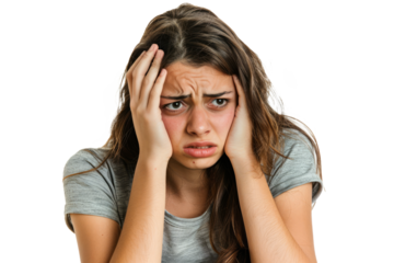 Young female sitting with her head in hands, face showing despair, isolated on a white background.