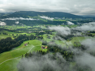 Aerial view landscape with low level clouds and overcast sky in the Bregenz Forest Mountains,...