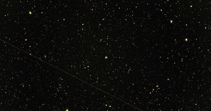 M57 Ring nebula and a passing satellite