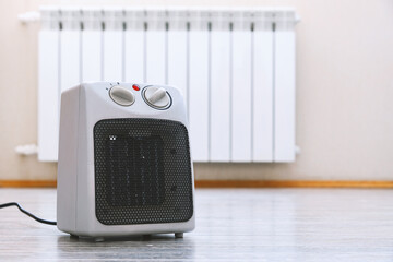 Electric fan heater on floor in living room, closeup