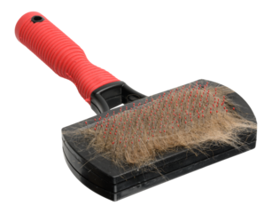 Comb for dogs and cats with fur on isolated background