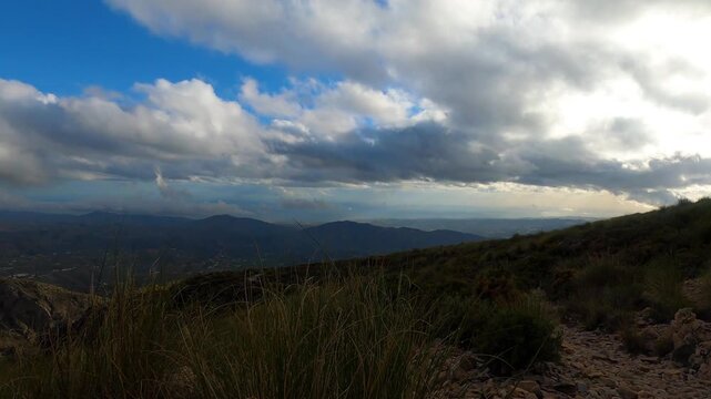 Fog and clouds on hiking trail to Maroma peak in thunderstorm day, Sierra Tejeda, Spain 