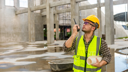 Architects engineer are checking the progress of the building project and checking the accuracy of the building plan.