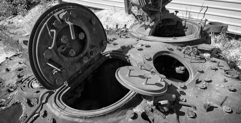 The rusty turret of a heavy strike tank with open hatches, showing significant wear and decay after fighting in Ukraine, Kyiv.