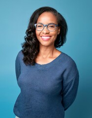 A woman wearing glasses and a smile on her face