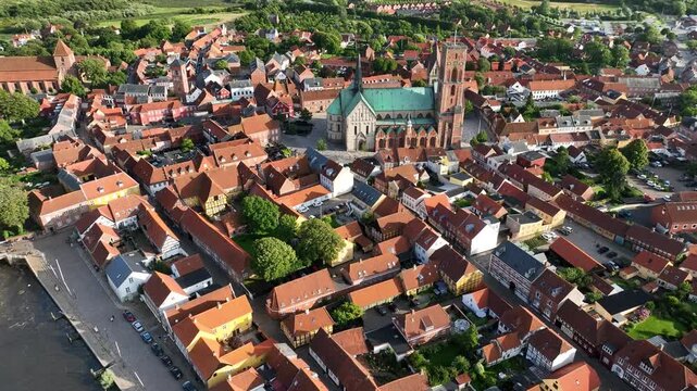 Shot of historic Ribe with its red-roofed buildings, half-timbered houses, Ribe Cathedral Square and impressive Ribe Cathedral, south-west Jutland, Denmark.