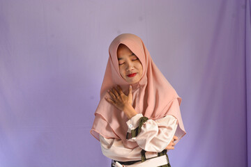 Portrait of Asian Muslim female student in white shirt smiling at the camera