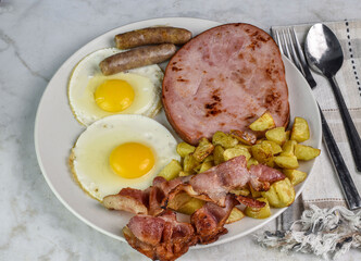 fried eggs  with ham, bacon and sausage