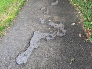Potholes in a badly maintained asphalt path