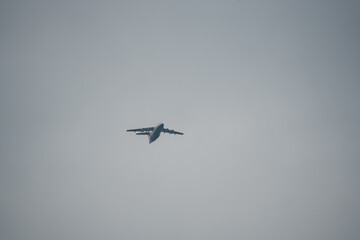 a large military Airbus A400M transport aircraft flying low on a parachute drop run
