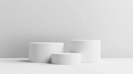 Three White Cylindrical Platforms on a White Surface